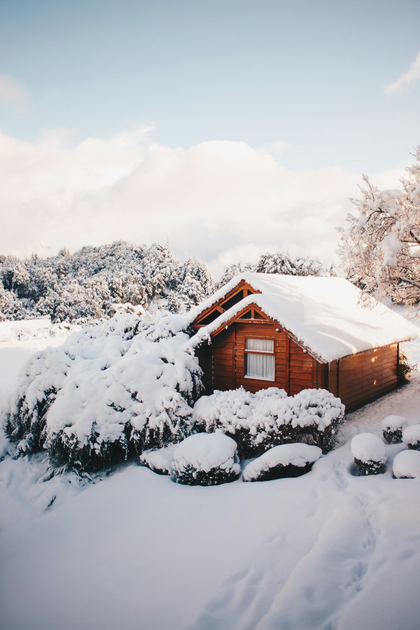 Wooden chalet covered in snow