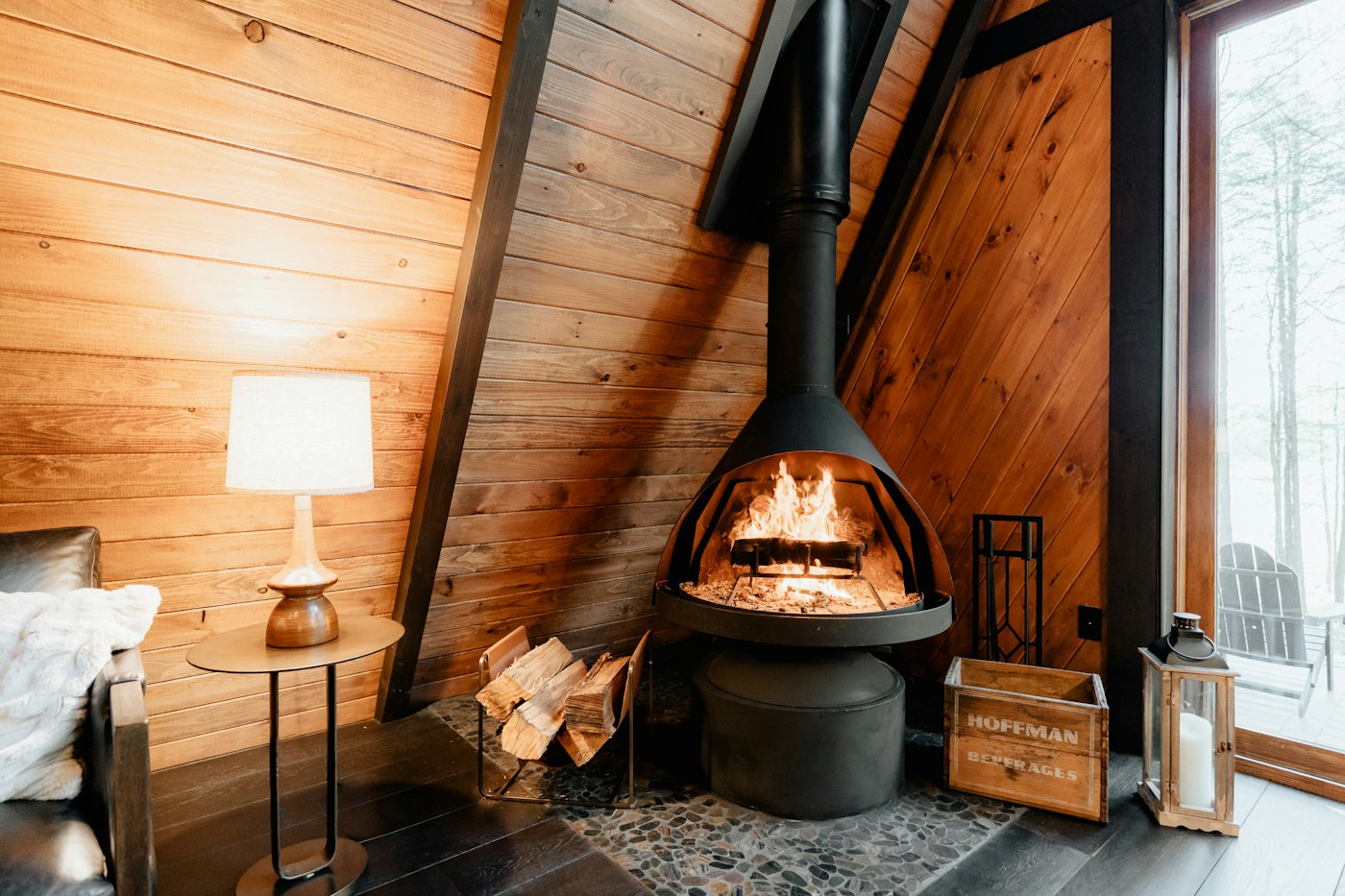 Wood stove burning inside an A-frame cabin